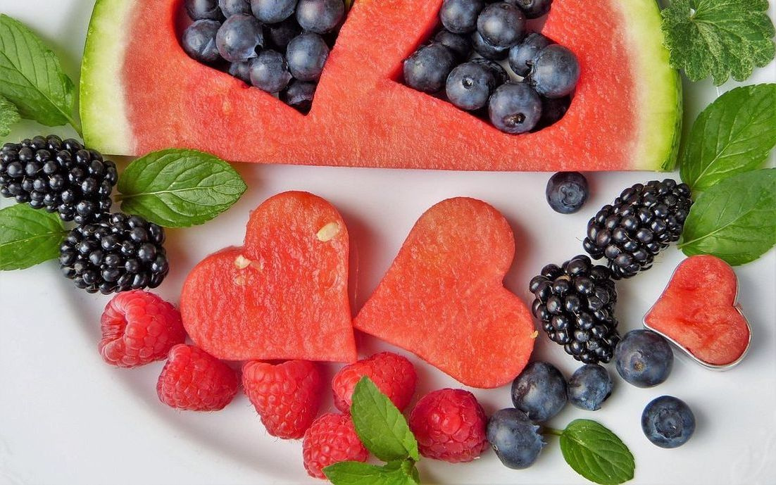 A bowl of fresh berries and watermelon slices